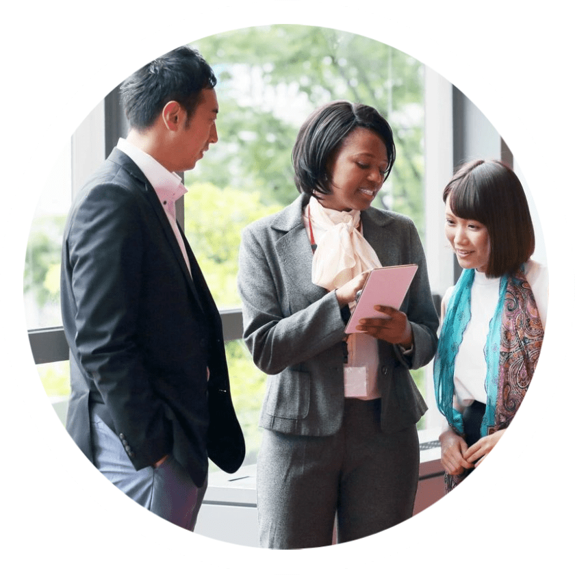 Three people standing around talking to each other.