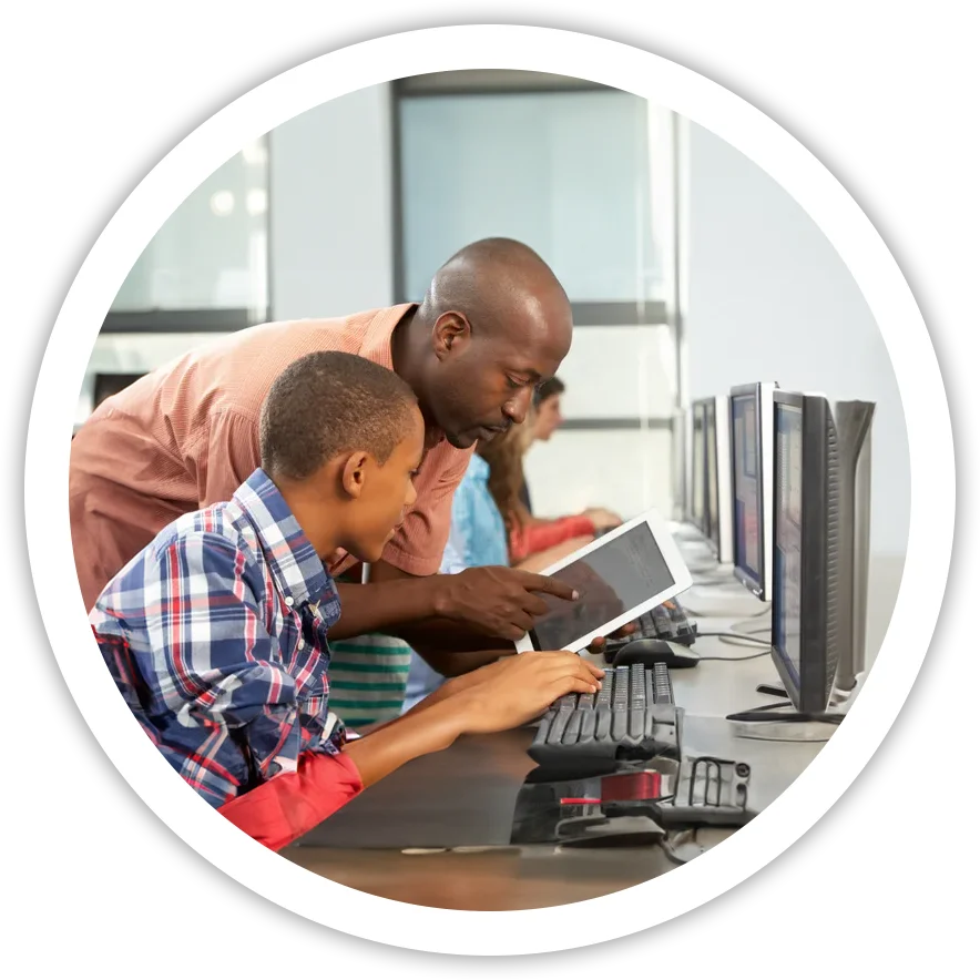 A man and boy looking at an ipad.